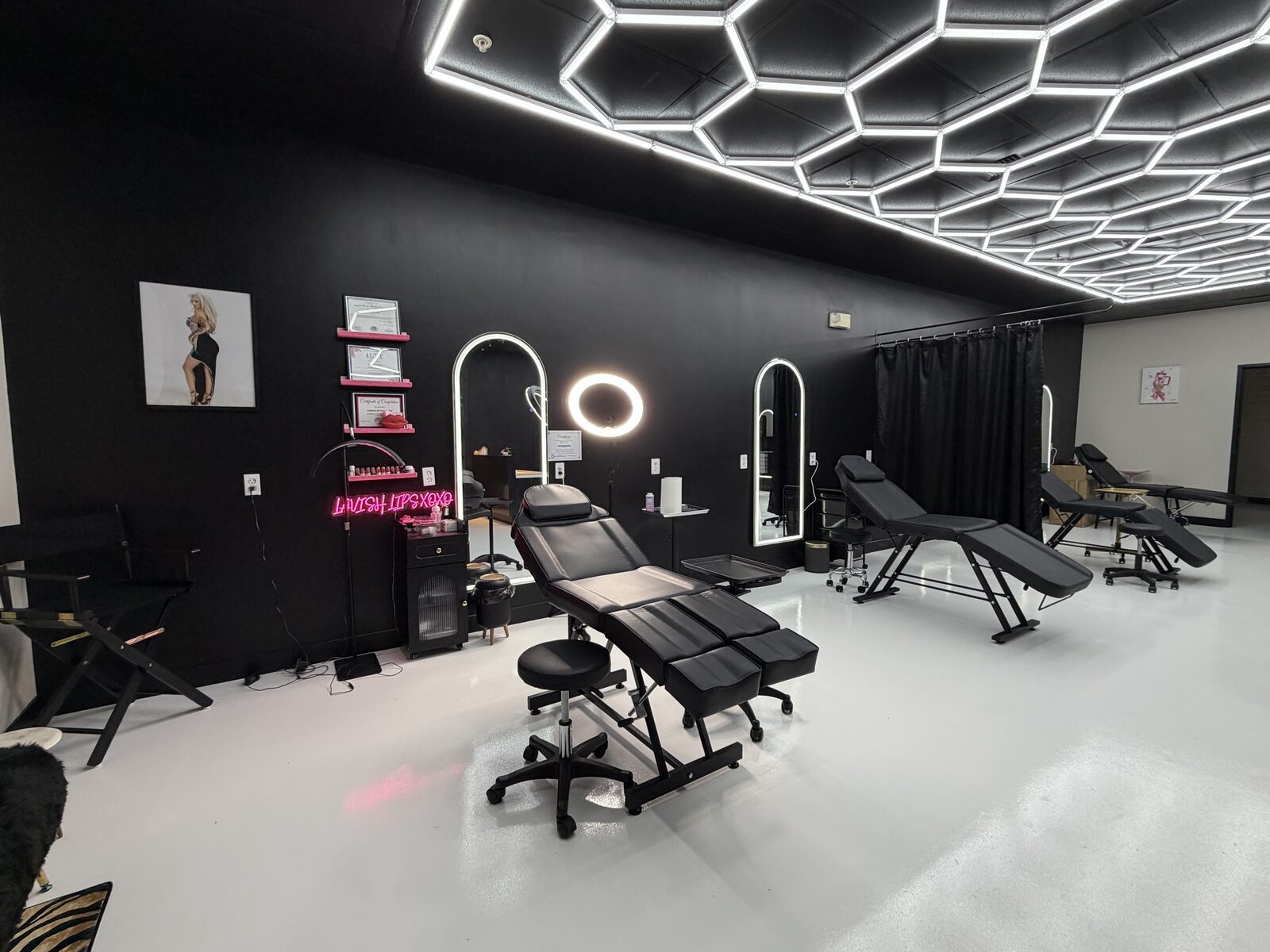Lavish Lips XOXO studio interior with hex ceiling lights and neon sign